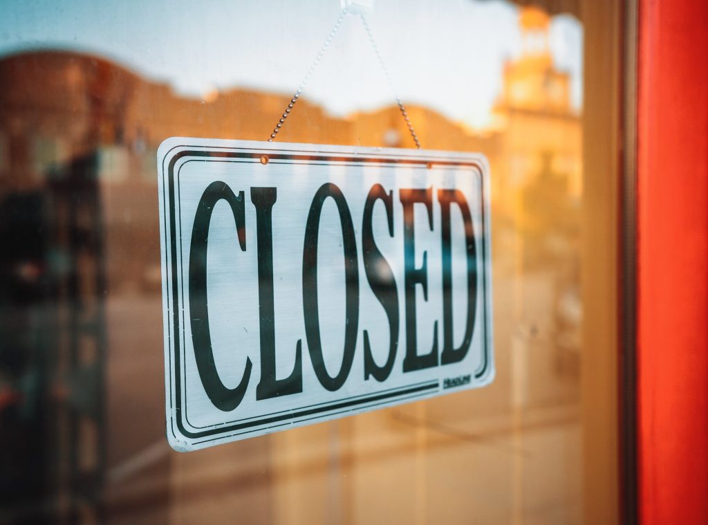 A closed sign in a window of a door