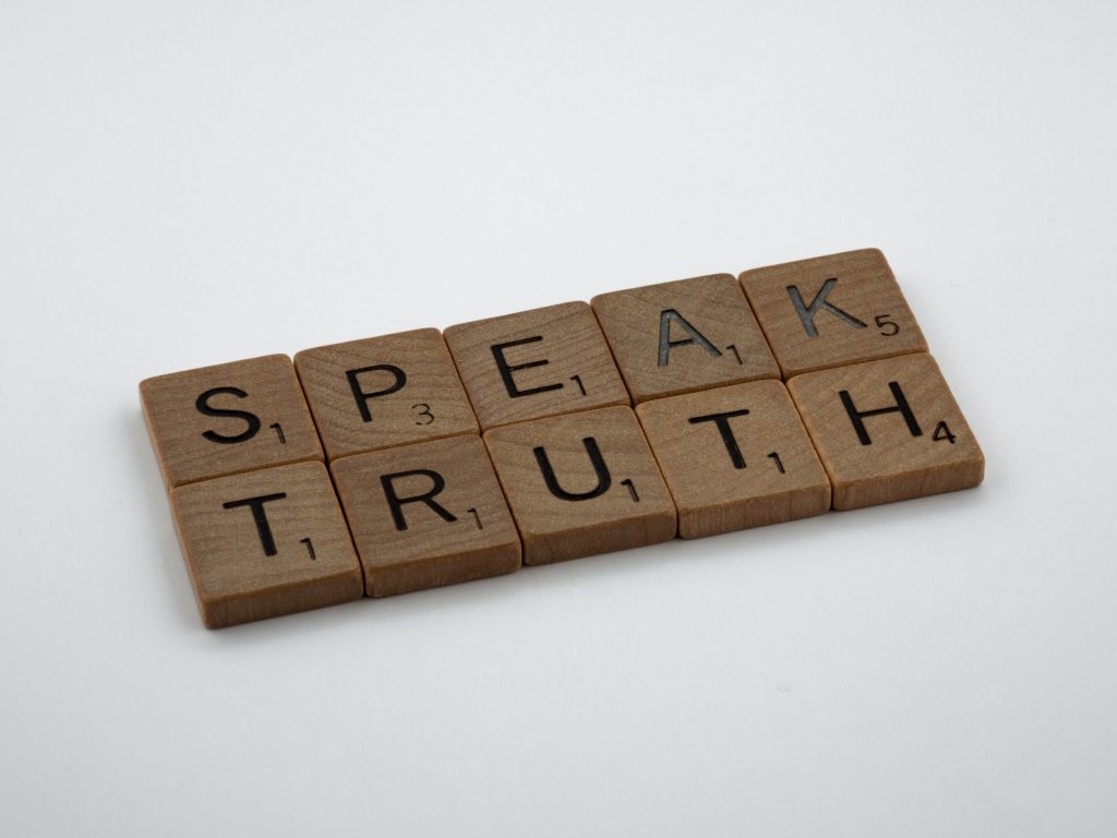 Scrabble tiles that read "speak truth"