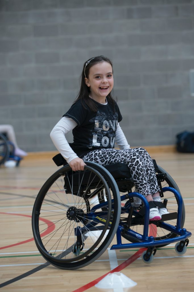 A young girl in a wheelchair