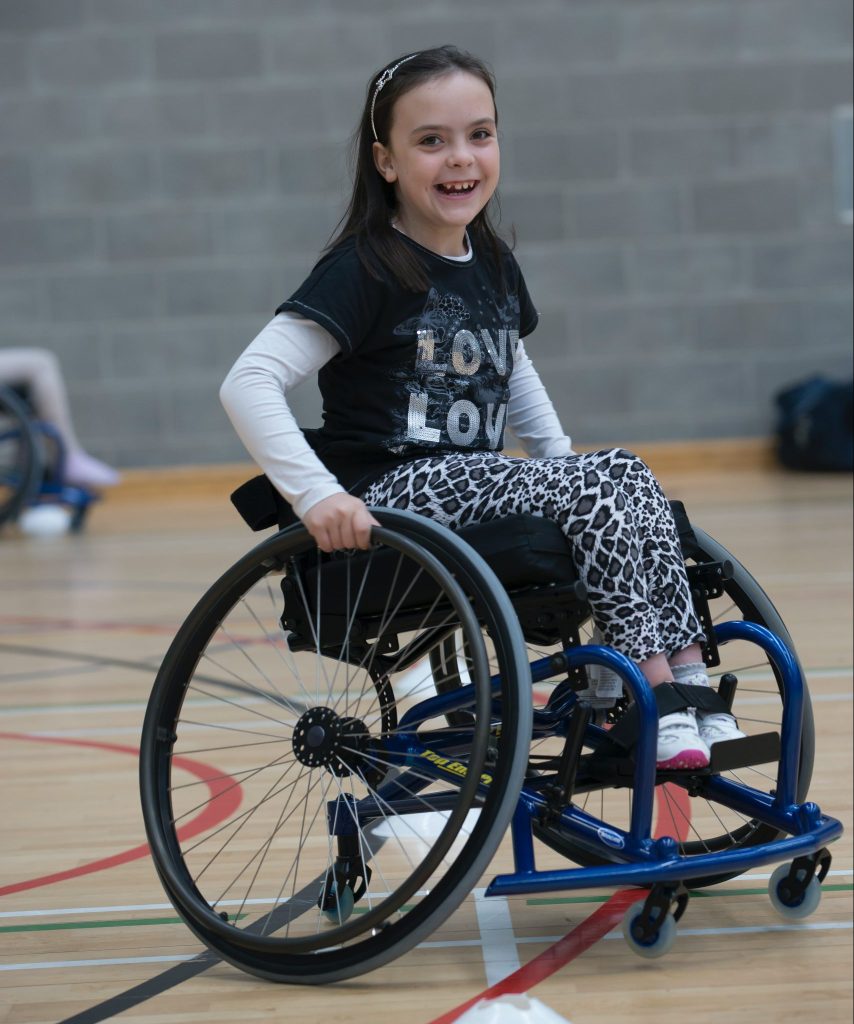 A young girl in a wheelchair