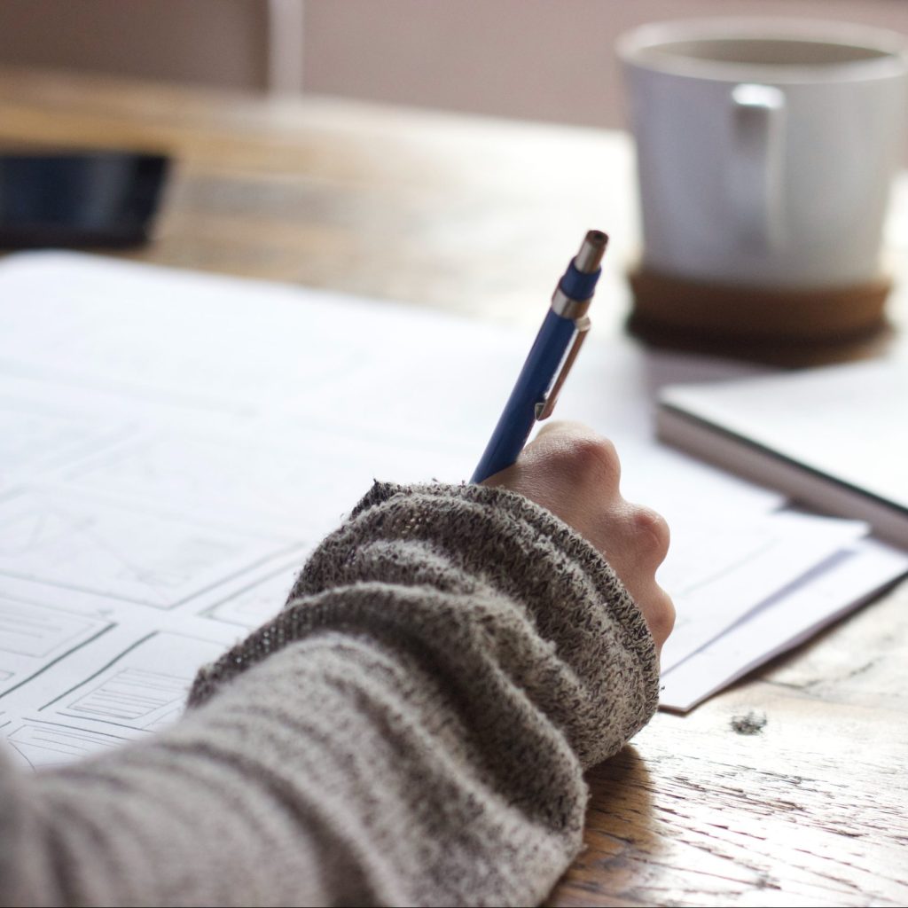 a photograph of a hand holding a pen