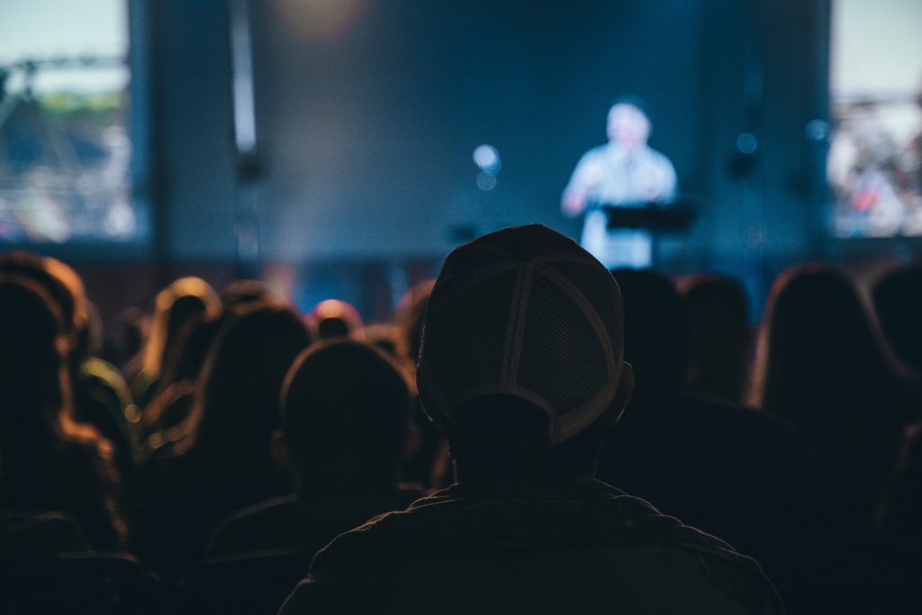 A photograph of an event, taken from the crowd